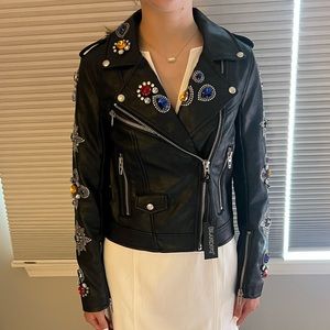 Black leather jacket with sparkle and hem details on front and sleeves